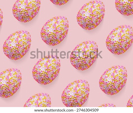 Repeat design of glossy eggs over pink background, creative flat lay from decorative sparkly Chicken egg, minimal pastel pattern, for packaging, social media display, Easter food celebration concept