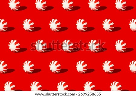 A repeat pattern of peppermints starlight mints on a red background.