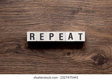 Repeat - word concept on building blocks, text, letters