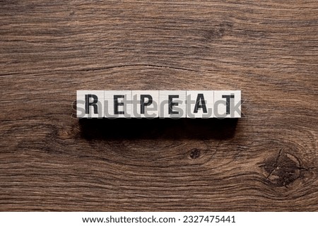 Repeat - word concept on building blocks, text, letters