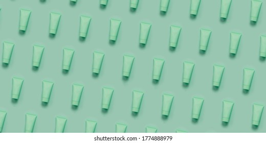 Repeated Pattern of hand cream tubes with cosmetic. Concept of scin care and anti aging natural cosmetics. Open composition
