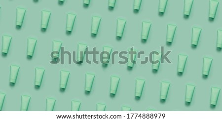 Repeated Pattern of hand cream tubes with cosmetic. Concept of scin care and anti aging natural cosmetics. Open composition
