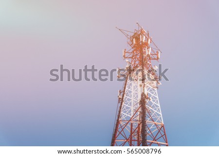 repeater tele communication tower with blue sky on background. Cell phone tower used to transmit telephony signal. Toned image with copy space.
