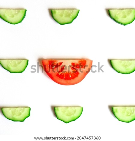 repeating pattern of sliced semicircles of fresh raw vegetable cucumbers for salad and a slice of tomato in the center isolated on a white background flat lay, top view. square