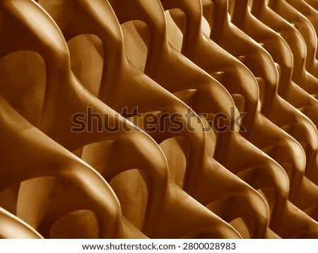 Repeating teardrop relief pattern on glossy panel surfaces, sculptural texture.