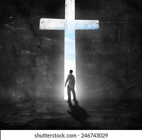 Repentance Concept: Silhouettes Black And White Humble Man Standing Over Cross In Dark Room Background