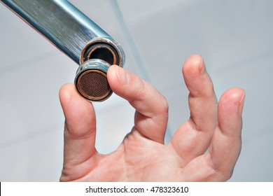 Replace A Sink Aerator, Unscrew The Aerator Shell Of Tap, Remove The Old Aerator, Handyman Hand Close-up.