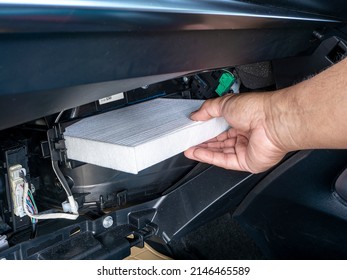 Replacement Air Filter For Car. Hand Of The Car User For Maintenance Airconditioner Filter By Replacement Concept DIY Inside His Car