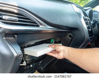 Replacement Air Filter For Car. Hand Of The Car User For Maintenance Airconditioner Filter By Replacement Concept DIY Inside His Car.