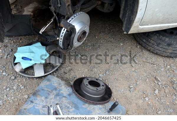 replacement of the brake disc at the\
car in domestic conditions. the car repairman removes the worn\
brakes and puts on new ones. has tools and a mounting\
pad