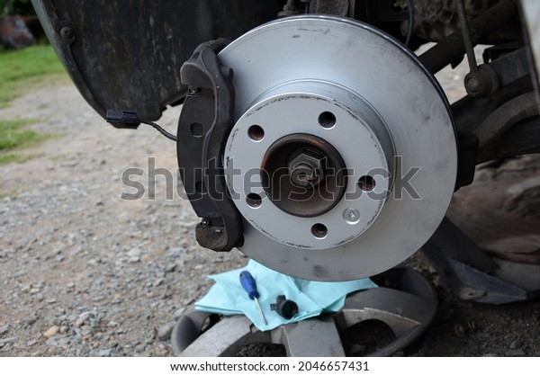 replacement of the brake disc at the\
car in domestic conditions. the car repairman removes the worn\
brakes and puts on new ones. has tools and a mounting\
pad