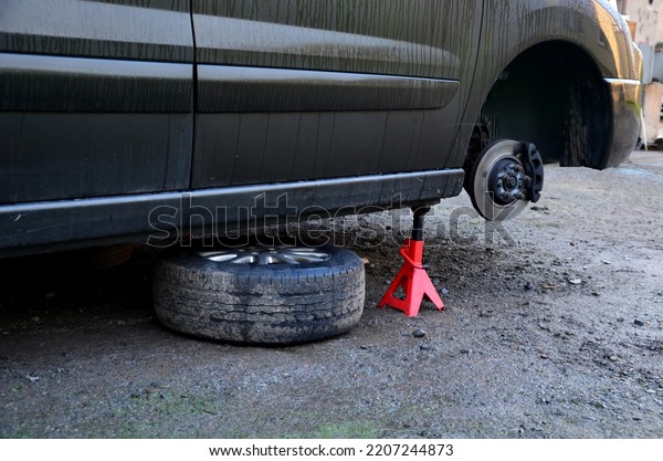 replacement of a brake disc in\
a car in domestic conditions. the auto mechanic removes the worn\
brakes and installs new ones. has tools and mounting pad, stand,\
jack