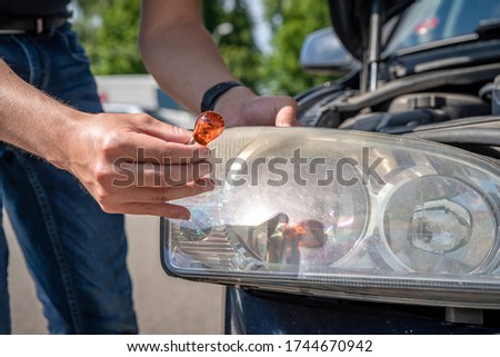 replacement of the bulb in the front headlight of a passenger car