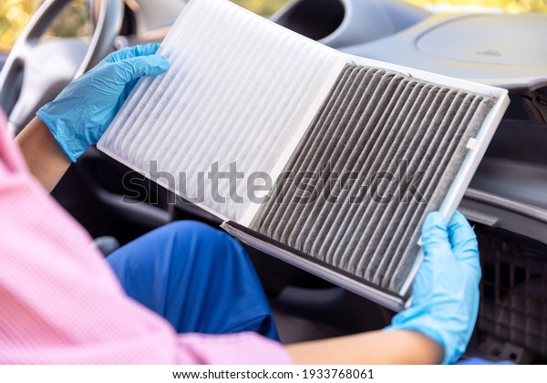 Replacement of cabin pollen air filter for a\
car. Basic auto mechanic skills\
concept.