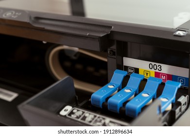 Replacement of CMYK set of ink cartridges in printer - Shutterstock ID 1912896634