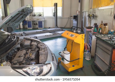 Replacement Of The Coolant On The Car With The Help Of A Special Stand In The Auto Repair Shop