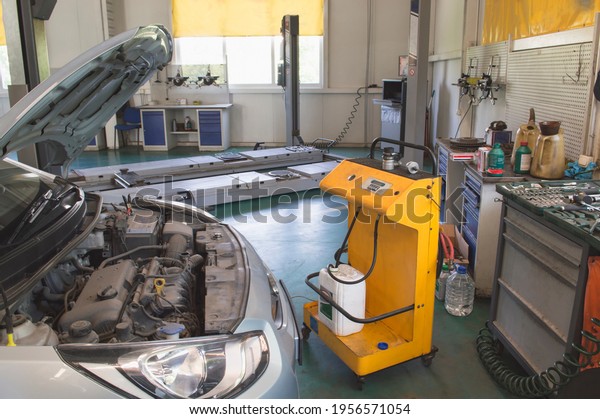 Replacement of the coolant on the car\
with the help of a special stand in the auto repair\
shop