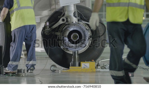 Replacement landing gear. Working\
staff has been working to repair the chassis of a passenger\
plane