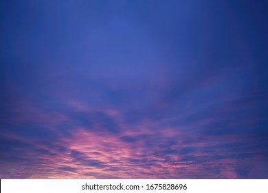 Replacement sky for editing. Pink cloudy sky turning to deep blue with beautiful surface.