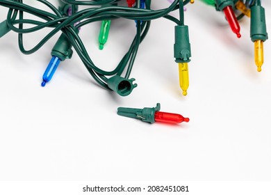 Replacing Christmas String Lights Bulb. Holiday Lighting Repair, Safety And Decoration Concept.