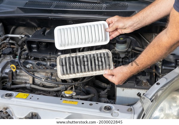 Replacing the dirty\
engine air filter for a\
car