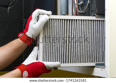 Replacing the filter in the central ventilation system. Replacing Dirty Air filter for home central air conditioning system. Change filter in rotary heat exchanger recuperator.