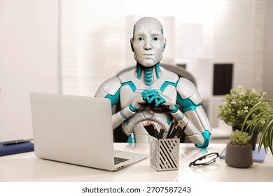 Replacing humans with artificial intelligence. Robot working at table in office. Futuristic technologies - Powered by Shutterstock - Get 15% off with code: PIKWIZARD15