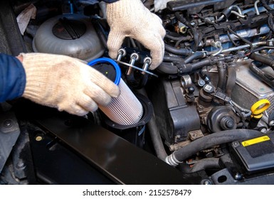 Replacing a new fuel filter on a modern car to clean the fuel from dirt. - Shutterstock ID 2152578479