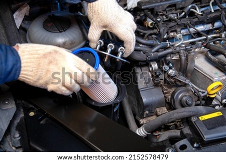 Replacing a new fuel filter on a modern car to clean the fuel from dirt.