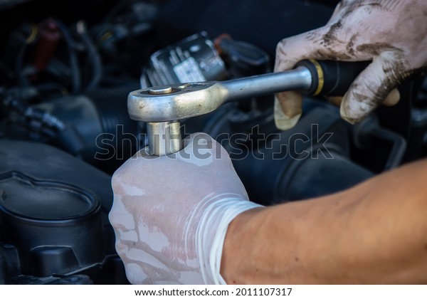 replacing the\
oil filter on the car. Selective\
focus