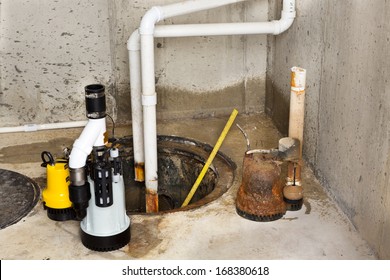 Replacing The Old Sump Pump In A Basement With A New One To Drain The Collected Ground Water From The Sump Or Pit