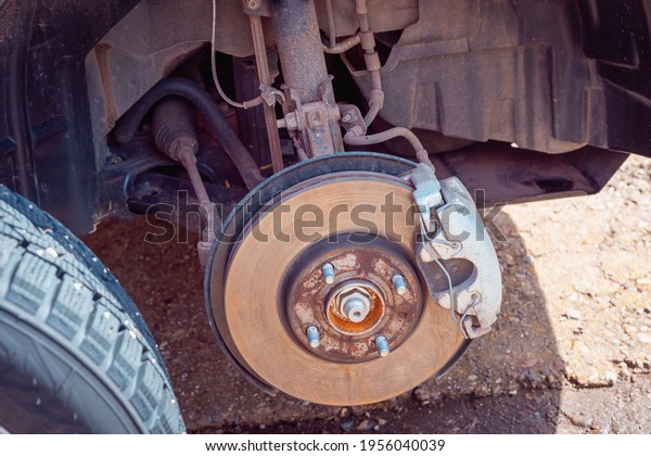 Replacing a punctured car\
wheel.