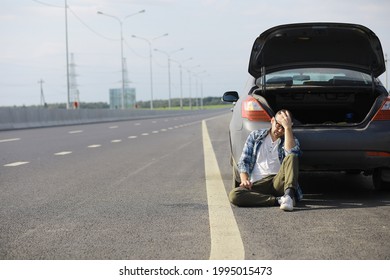 Replacing The Wheel Of A Car On The Road. A Man Doing Tire Work On Sidelines.