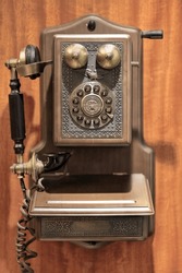 Replica Of An AD1907 Paramount Antique Classic Wooden Wall Mounted Landline Phone With Push Button Dial In Rotary Plate, Handset With Brown Felted Cord, Antique Metal Accents, Brass Ringers And Crank.