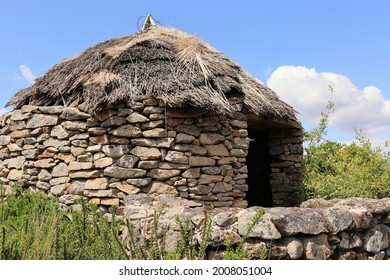 Replica of an ancient Celtic castro, with its stone walls and thatched roof. Castromao. Celanova. Orense. Galicia. Spain. - Shutterstock ID 2008051004