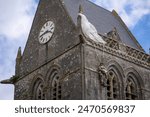 A replica of former U.S. Army Private 1st Class John Steele hangs from the roof of the Church of Sainte-Mere-Eglise by his parachute, Sainte Mere Eglise, Normandy, France