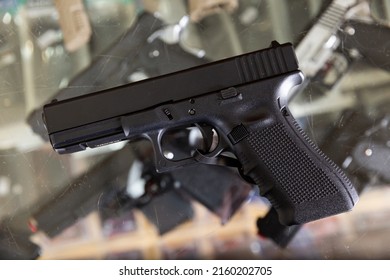 Replica Of Handgun On Showcase In Military Goods Store. Airsoft Weapon.