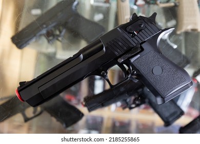 Replica Of Handgun On Showcase In Military Goods Store. Airsoft Weapon.