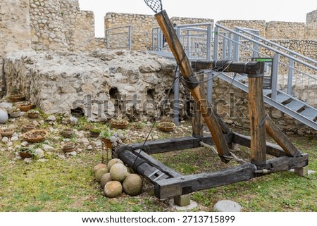 Replica of a siege engine and cannonballs inside the Golubac Fortress