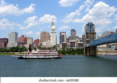 Replica Steamboat Travels Down The Ohio River In Front Of The Cincinnati Skyline.