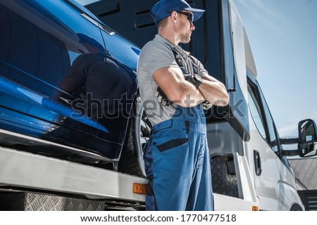 Repo Man in Front of His Truck. Car Loan Problems and Vehicle Repossession Theme. Vehicle Financing and Repo Company.