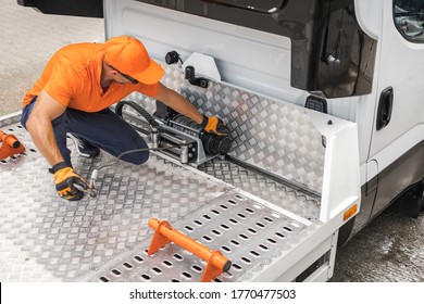 Repo Man Preparing His Towing Truck For the Next Day of Repossession Work