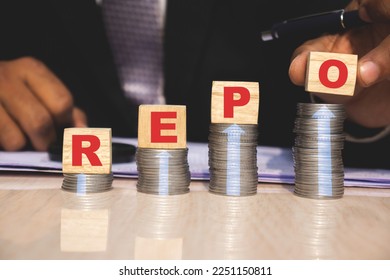 repo repurchasing agreement rate bank loan on wooden cube, concept of business, company, debt, high, increase, hike, rate,