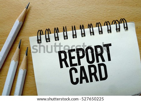 Report Card text written on a notebook with pencils