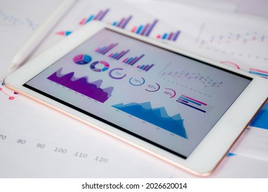 Report Graph And Chart Of Investment With Finance On Tablet Computer On Desk, Datum Of Stock And Growth, Planning And Statistic With Economic, No People, Digital Marketing, Business Concept.