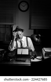 Reporter Working Late At Night And Smoking In His Office, 1950s Film Noir Style.