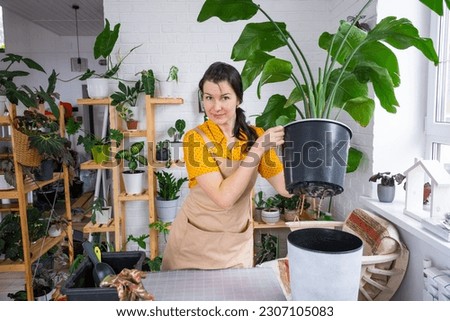 Similar – Woman in work wear in her workshop by table with handmade items