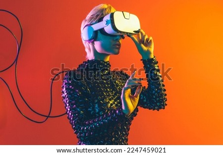 Representation of a bionic super human with advanced technology parts as vr visors and gadgets playing in a mixed reality training room. Futuristic cyberpunk evolution of human mankind and AI