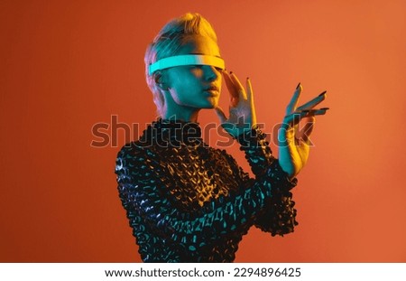 Representation of a bionic super human with advanced technology parts as vr visors and gadgets playing in a mixed reality training room. Futuristic cyberpunk evolution of human mankind and AI