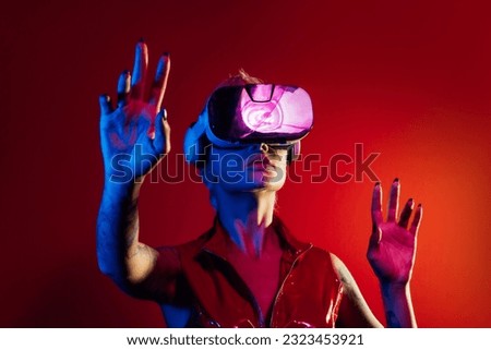 Representation of a bionic super human with advanced technology parts as vr visors and gadgets playing in a mixed reality training room. Futuristic cyberpunk evolution of human mankind and AI